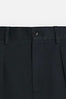 PLEATED CHINO PANTS