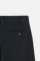 PLEATED CHINO PANTS