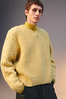 Relaxed fit sweater of spun wool fabric. V-neck and long sleeves. Rib trim.