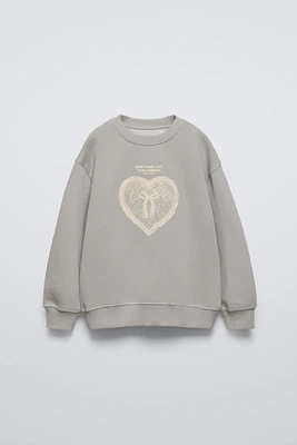 RAISED HEART SWEATSHIRT