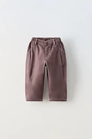 PLEATED PANTS WITH TOPSTITCHING