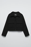 Collared cardigan with long sleeves. Snap button closure at front. Flap patch pockets chest.