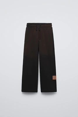 WASHED EFFECT LABEL PANTS