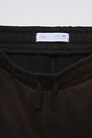 WASHED EFFECT LABEL PANTS