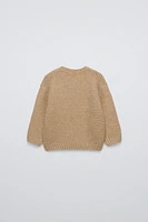 Knit sweater with round neck and long sleeves. Bear embroidery at chest.