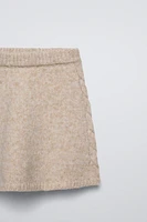 knit skirt with elastic waistband. Cable sides.