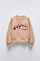 FLOCKED TEXT STAR SWEATSHIRT