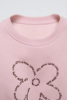 EMBROIDERED TEXT FLOWER SWEATSHIRT