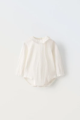 TEXTURED BODYSUIT WITH RUFFLE