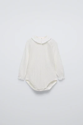 TEXTURED BODYSUIT WITH RUFFLE