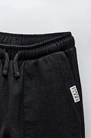 LABEL DETAIL TEXTURED PANTS