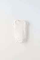 FIVE PACK OF BODYSUITS WITH BOWS