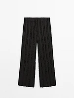 Trousers with fringe detail