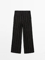 Trousers with fringe detail