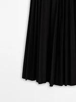 Pleated skirt with leather detail