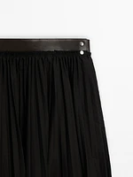 Pleated skirt with leather detail