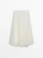 Long voluminous skirt with seams