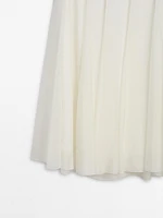 Long voluminous skirt with seams