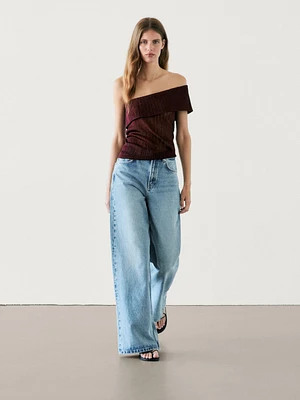 Semi-sheer ribbed top with an asymmetric neckline