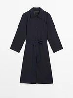 Flowing navy blue trench coat with belt