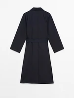 Flowing navy blue trench coat with belt