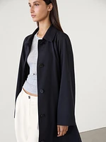 Flowing navy blue trench coat with belt