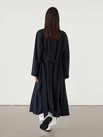 Flowing navy blue trench coat with belt