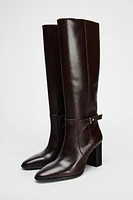 BUCKLED KNEE HIGH HEELED LEATHER BOOTS