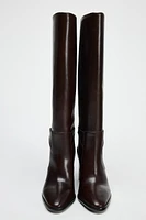 BUCKLED KNEE HIGH HEELED LEATHER BOOTS