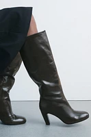 Knee high boots made of leather. Wide shaft. Rounded toe. Zip closure. <br/><br/>Heel height: 3.3 inches (8.5 cm)