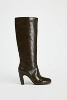 Knee high boots made of leather. Wide shaft. Rounded toe. Zip closure. <br/><br/>Heel height: 3.3 inches (8.5 cm)