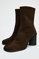 Suede boots. Block heels. Zip closure. Rounded toe. <br/><br/>Heel height: 3.1 inches (8 cm)