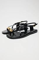 FLAT STRAPPY SANDALS WITH METAL EMBELLISHMENT