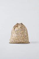 Bag with floral print. Adjustable lace-up closure.<br/><br/>Height x Length x Width: 13 x 11.4 x 0.8 inches (33 x 29 x 2 cm)