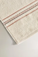 TOWEL WITH CREASED EFFECT BORDER