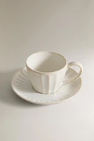 STONEWARE TEACUP AND SAUCER WITH RAISED DESIGN