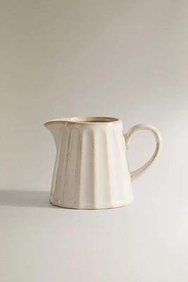 STONEWARE CREAM PITCHER WITH RAISED DESIGN