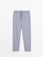 Striped pyjama bottoms and short sleeve T-shirt