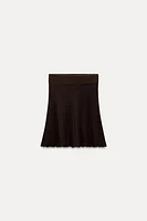 PLEATED SOLID KNIT SKIRT