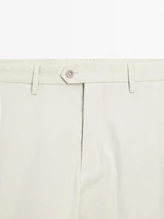 Tapered fit trousers with buckle detail