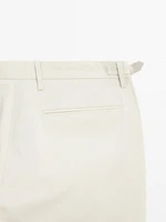 Tapered fit trousers with buckle detail