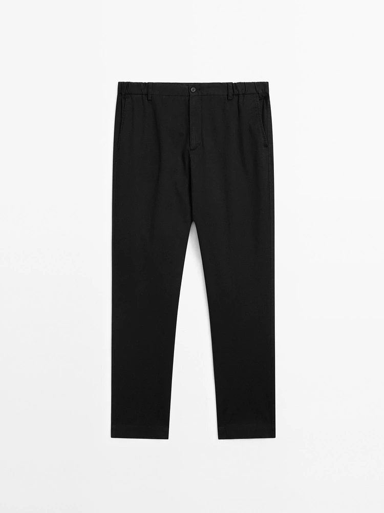 Tapered fit trousers with side elastic detail