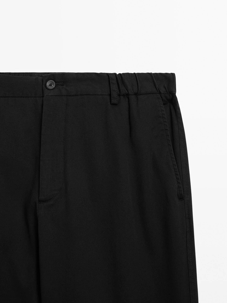 Tapered fit trousers with side elastic detail