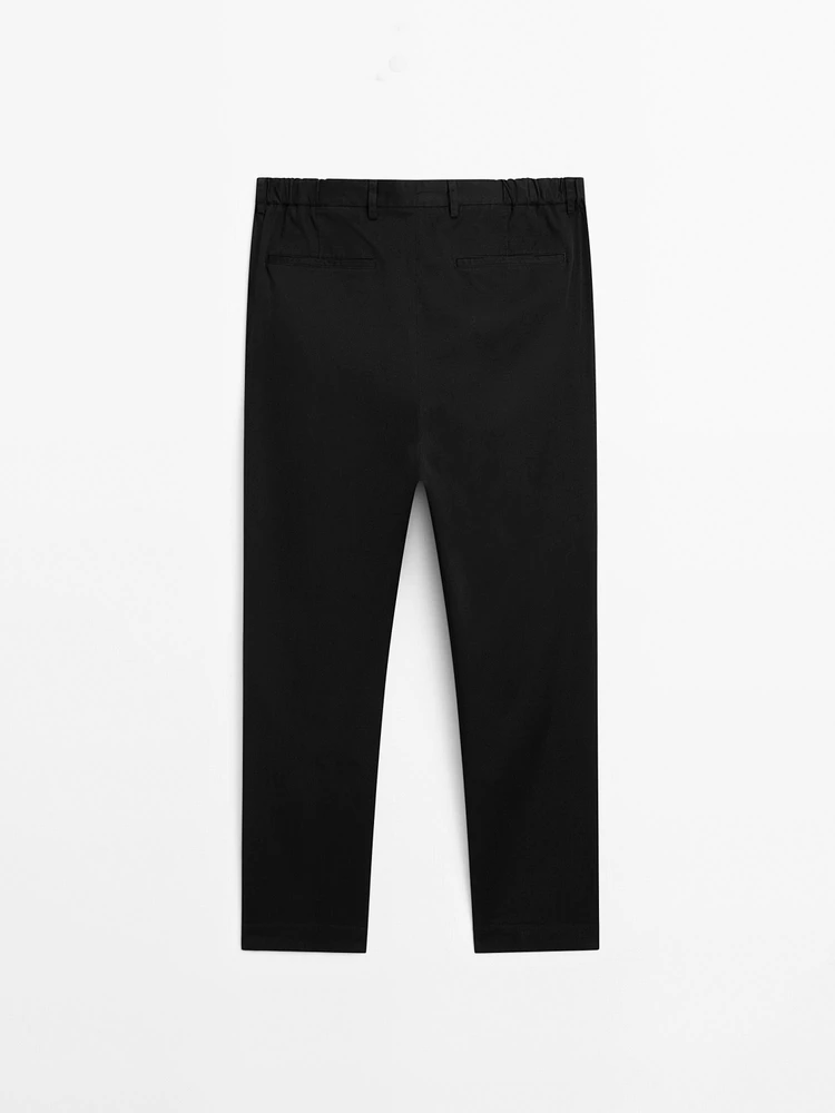 Tapered fit trousers with side elastic detail