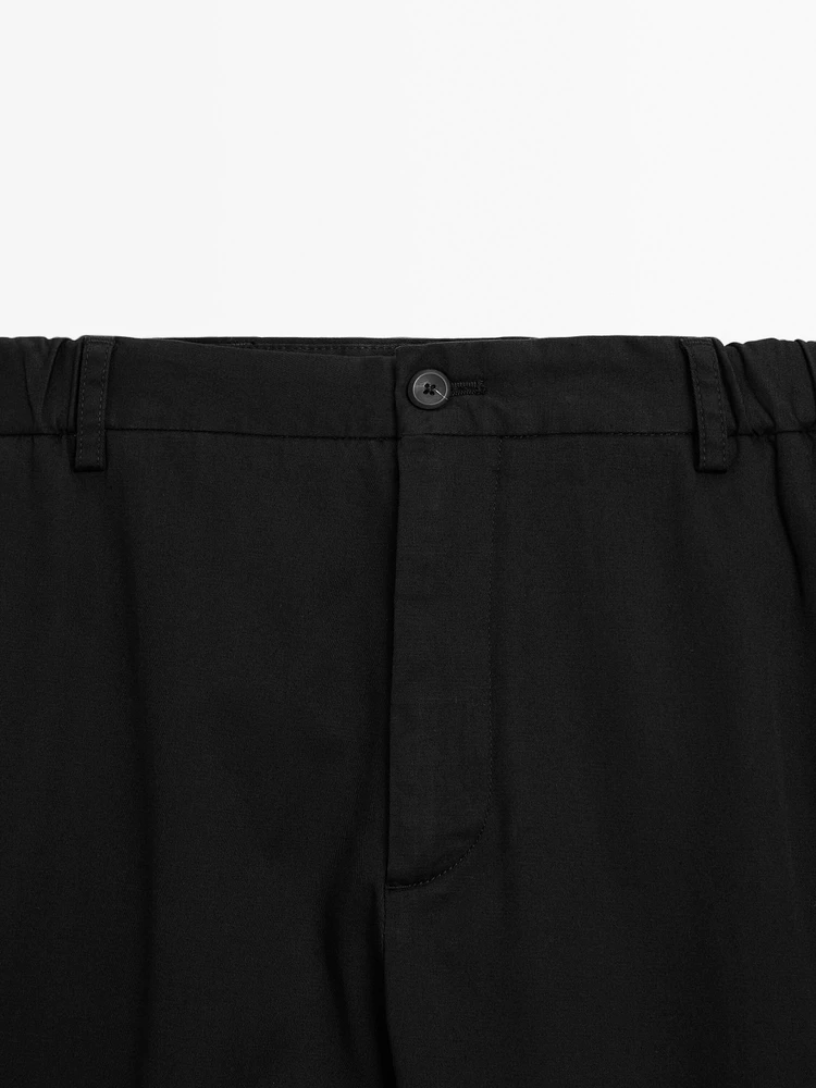 Tapered fit trousers with side elastic detail