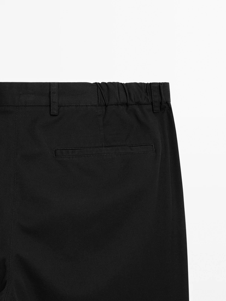 Tapered fit trousers with side elastic detail