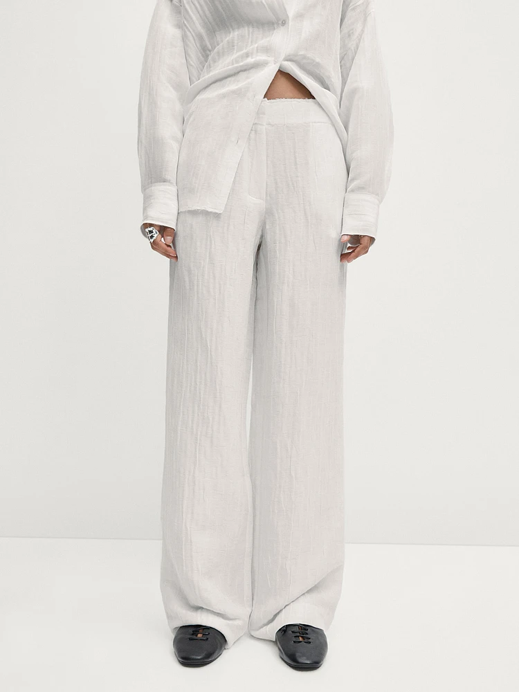 Flowing creased-effect trousers