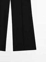 Flared trousers with zip