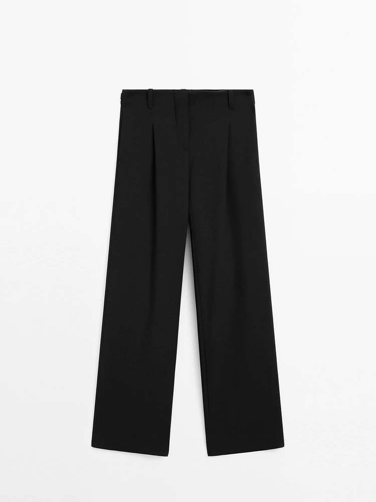 Flowing mid-waist trousers with buckles