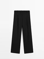 Flowing mid-waist trousers with buckles